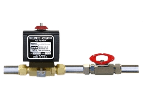Pneumatic actuator valve assembly featuring a black pneumatic actuator labeled with model and specifications, attached to a brass ball valve with a red handle and connected to metal piping on either side.