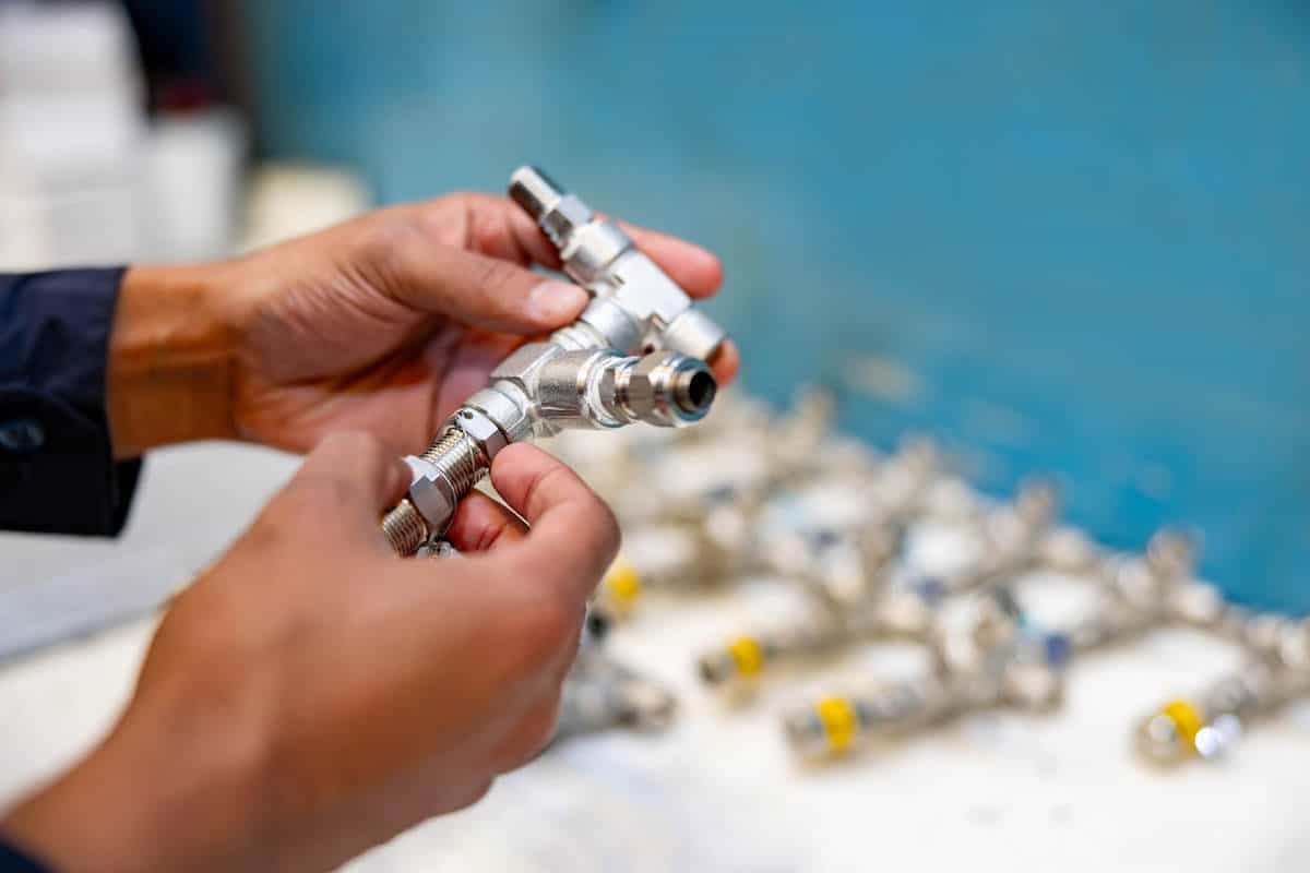 Close-up on a worker making pipeline valves at a factory.